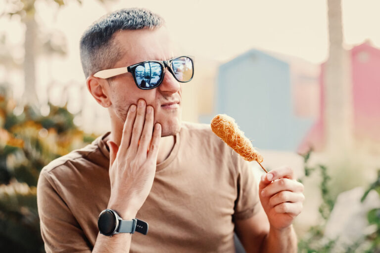 Man eating crispy shrimp kataifi experiences sudden toothache on vacation